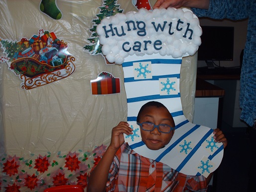A child holding up a hung with care sign